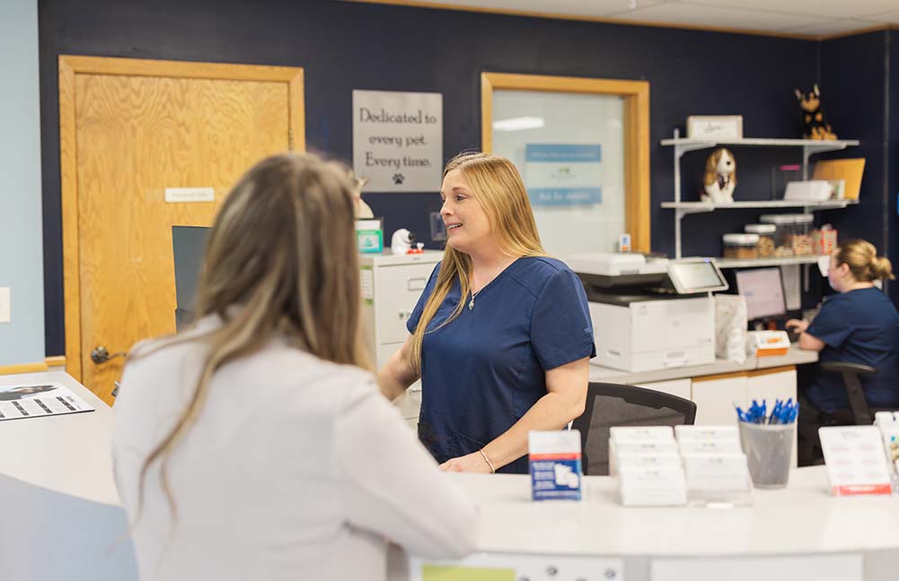 Smiling CSR customer service representative talks and laughs with client