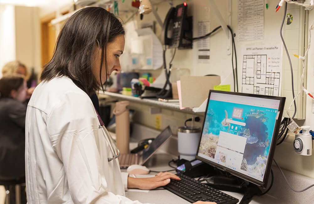 female vet sitting on computer