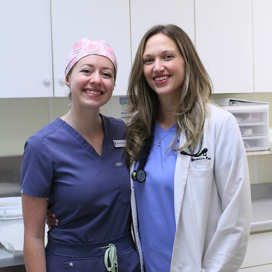 Two Vets Smiling two female vets in scrubs smiling for camera